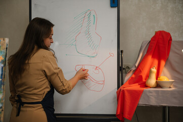 The artist explains in art class. Education and learning concept. Girl mixing and combining colors. Art lesson.