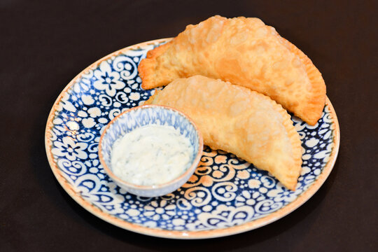 Russian cuisine is tasty chebureki fried dough with meat.