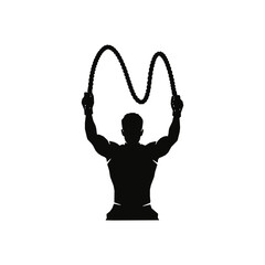 Silhouette of a Muscular Man Working Out with Battle Ropes for Fitness and Strength Training