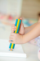 A Childs Delightful Hands Joyfully Holding Colorful Pencils for Creative and Fun Activities