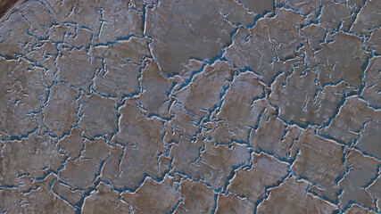 Aerial view of a cracked, parched earth reveals a stark landscape, with fissures creating an intricate web of textures, Sunnyvale, California, United States.