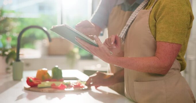 Hands, tablet and couple in kitchen with vegetables, home and scroll online for recipe. People, chef and partner for cooking food with notes, ingredients or typing for meal prep on app at apartment