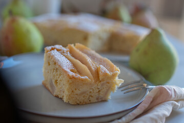 Homemade pear pie on a white table with pears 
