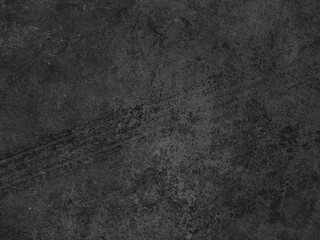Close up black tire marks on cement floor.