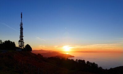 Communications tower. Antennas at sunset on Mount Jaizkibel, Basque Country