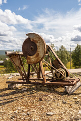 This large metal electric industrial circular saw, stands at the historic Olav's copper mine in R&oslash;ros, Norway, showcasing its engineering heritage.