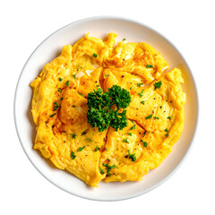 Overhead view of a fluffy, golden omelet on a white plate, garnished with herbs