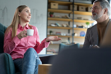Friendly colleagues having good relationships, conversation at workplace during coffee break