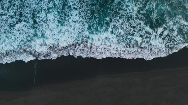 Aerial view of black sand volcanic beach with crashing waves Atlantic ocean, Serene and tranquil landscape