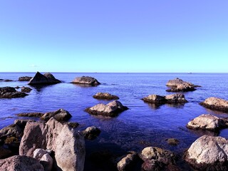 Obraz premium big stones in the blue sea transparent water
