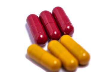 Pills. Tablets. Capsule. Heap of pills. Medical background. Close-up of pile of red white tablets - capsule. Pills and tablets.Blue background.