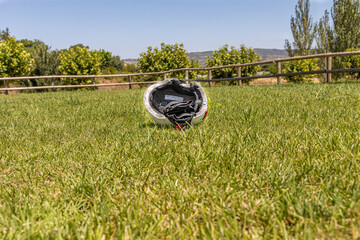 A white helmet on the green grass background