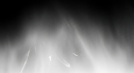 Monochrome Abstract Light Streaks Against a Dark Backdrop