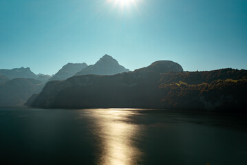 Autumn sun reflecting on the lake in the Alps in Switzerland