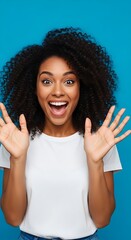 Excited woman with afro hairstyle expressing joy and surprise.