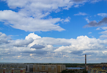 Panoramic cityscape with clouds and apartments