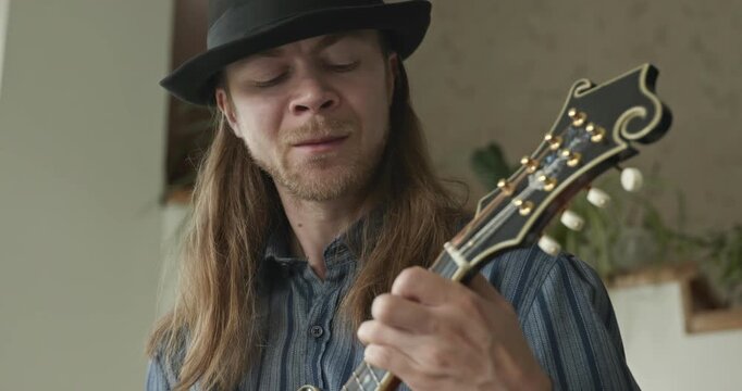 Male Musician Plays Mandolin. Caucasian Man Enjoys Playing Music 4K 10-bit