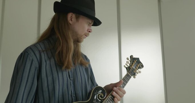 Male Musician Diligently Take Care of Instrument. Wipe Dust from Mandolin 4K 10-bit