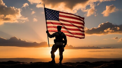 Silhouette of soldier holding American flag at sunset on mountain honoring military service and patriotism
