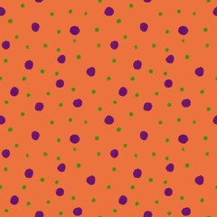Colorful polka dot pattern on an orange background with green and purple dots