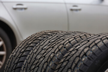 Winter studded car tires. Seasonal wheel replacement. Preparing transport for winter. Selective...