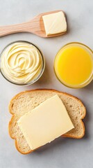 Toasted slices with cream cheese lie on a wooden board, accompanied by refreshing orange juice and a bowl of cottage cheese for a delightful breakfast