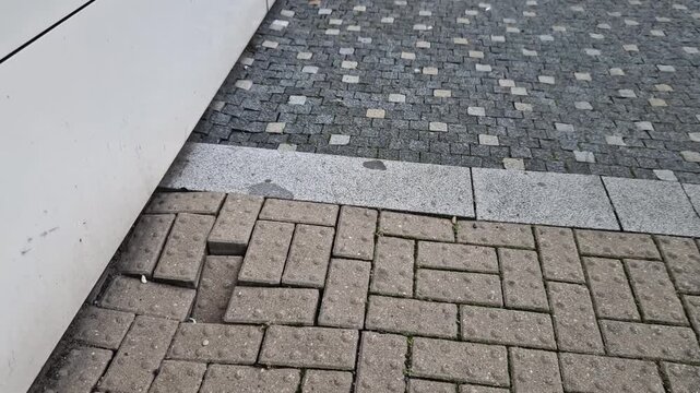 subsidence of the soil around the building's foundations causes a crooked floor. paving repair necessary