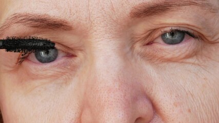 A middle-aged woman with mascara on her eyelashes, eye inflammation, and mascara allergy