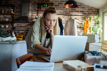 Young woman managing online business from home