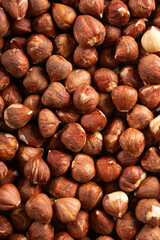 raw whole hazelnuts closeup, brown shells, natural snack, food texture