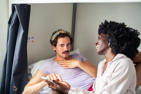 Roommates relaxing in hostel bunk