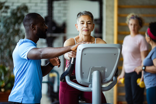 Senior woman exercising with trainer