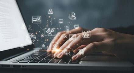 Close up of a person s hands typing on a laptop keyboard with glowing digital icons floating above the screen