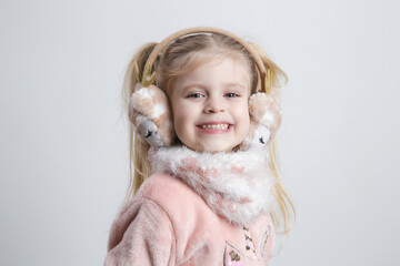 Adorable Little Girl Wearing Earmuffs and Cozy Scarf – Winter Kids Fashion Portrait
