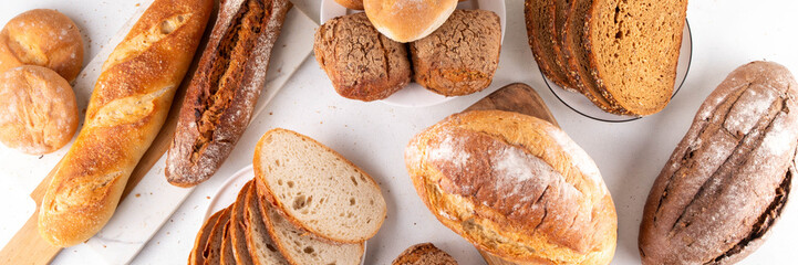 Set of various Prebiotic Bread with live bacteria, prebiotics, fiber for gut health. Healthy alternative to regular bread, different rye, white, grain bread and buns on white table background
