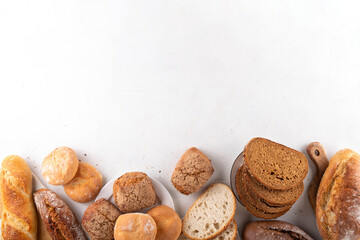 Set of various Prebiotic Bread with live bacteria, prebiotics, fiber for gut health. Healthy alternative to regular bread, different rye, white, grain bread and buns on white table background