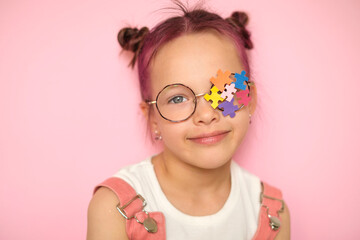 The girl decorated her glasses with pieces of multicolored puzzles as a sign of support and mercy for people with autism and ADHD.