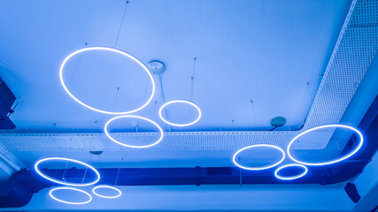 Circular luminaires on white ceiling. Circular LED luminaires on suspended ceiling, modern lighting...