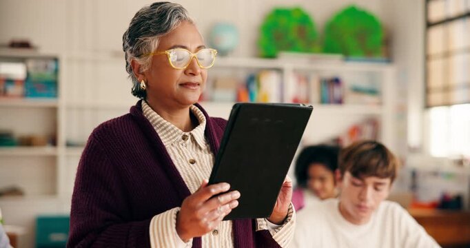 Mature woman, teacher and tablet in class for students attendance, lesson plan and assignment results. Female person, reading and digital for course schedule, curriculum information and test feedback