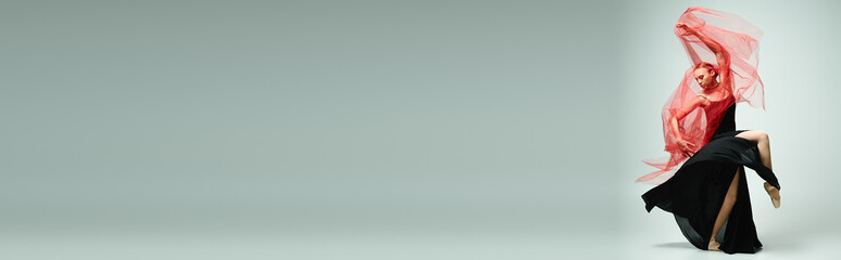 Elegant ballet dancer showcasing grace and poise with flowing fabric in a serene studio setting © LIGHTFIELD STUDIOS