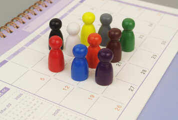Group of different people figures on calendar page.