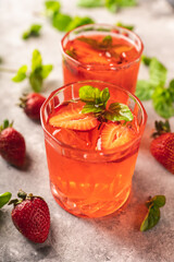 Gin based strawberry cocktail in old fashioned glass on rustic background. Alcohol drinks and cocktails.