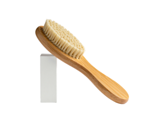 Close-up of a light brown wooden-handled brush with cream-colored bristles