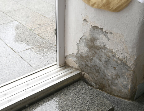 Water damage near entrance at building after heavy rainstorm c