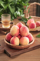 Fresh Ripe Peaches in Wicker Basket on Rustic Wooden Table - Organic Fruit Harvest