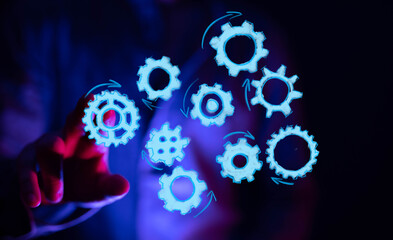 Image of hand interacting with glowing gears, symbolizing workflow, teamwork, and efficiency.