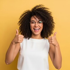 Joyful woman with curly hair gives thumbs up gesture isolated on white background