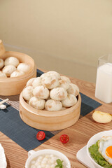 Traditional Chinese Steamed Buns Xiaolongbao in Bamboo Steamers with Breakfast Setup