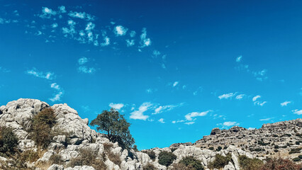 Majestic rock formations of limestone under blue sky with little clouds. National park of El Torcal...