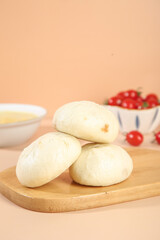 Fresh Handmade Steamed Buns on Wooden Board with Cherry Tomatoes Kitchen Scene